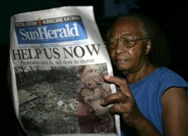 Mary Mason reads a newspaper in a rescue shelter at Biloxi Junior High School in Biloxi, Mississippi, September 1, 2005.